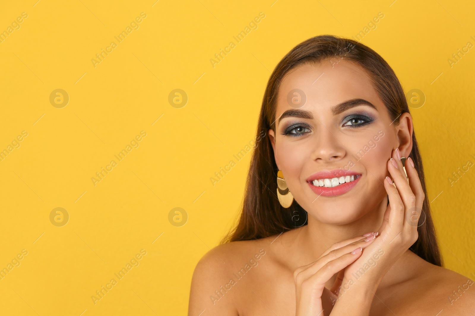 Photo of Portrait of beautiful woman with stylish makeup on color background. Space for text