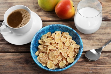 Bowl with healthy cornflakes for breakfast served on wooden table