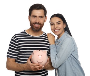 Photo of Happy couple with ceramic piggy bank on white background