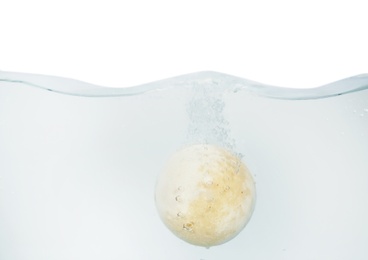 Bath bomb in water on white background