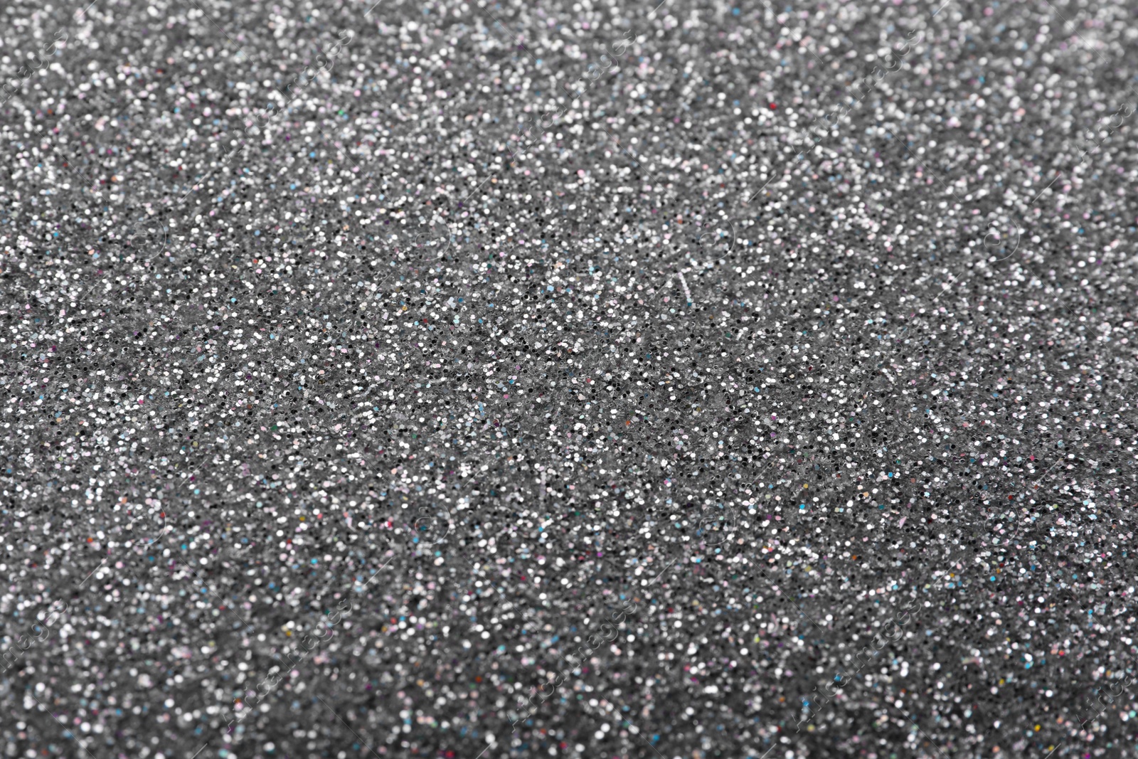 Photo of Beautiful shiny grey glitter as background, closeup