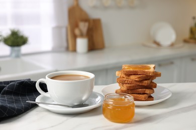 Breakfast served in kitchen. Fresh toasts, coffee and honey on white marble table