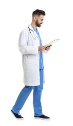 Young male doctor in uniform with clipboard isolated on white