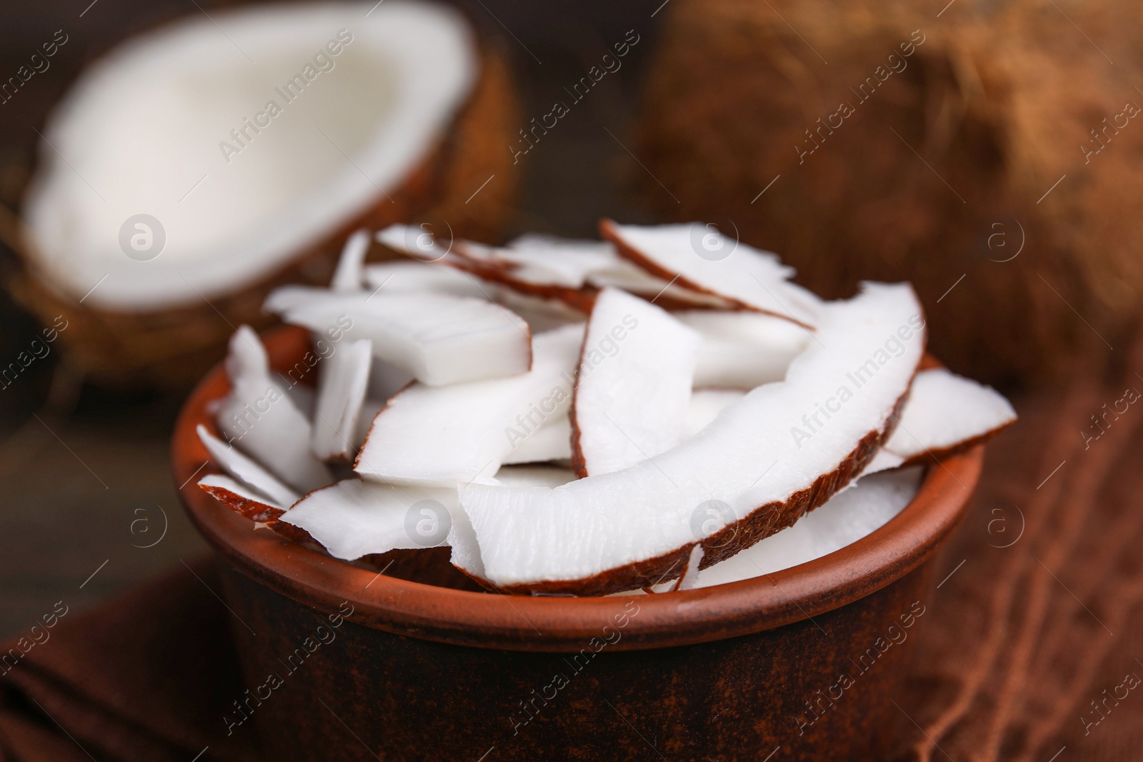 Photo of Coconut pieces in bowl on table, closeup