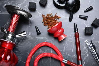 Photo of Flat lay composition with parts of hookah on black marble table
