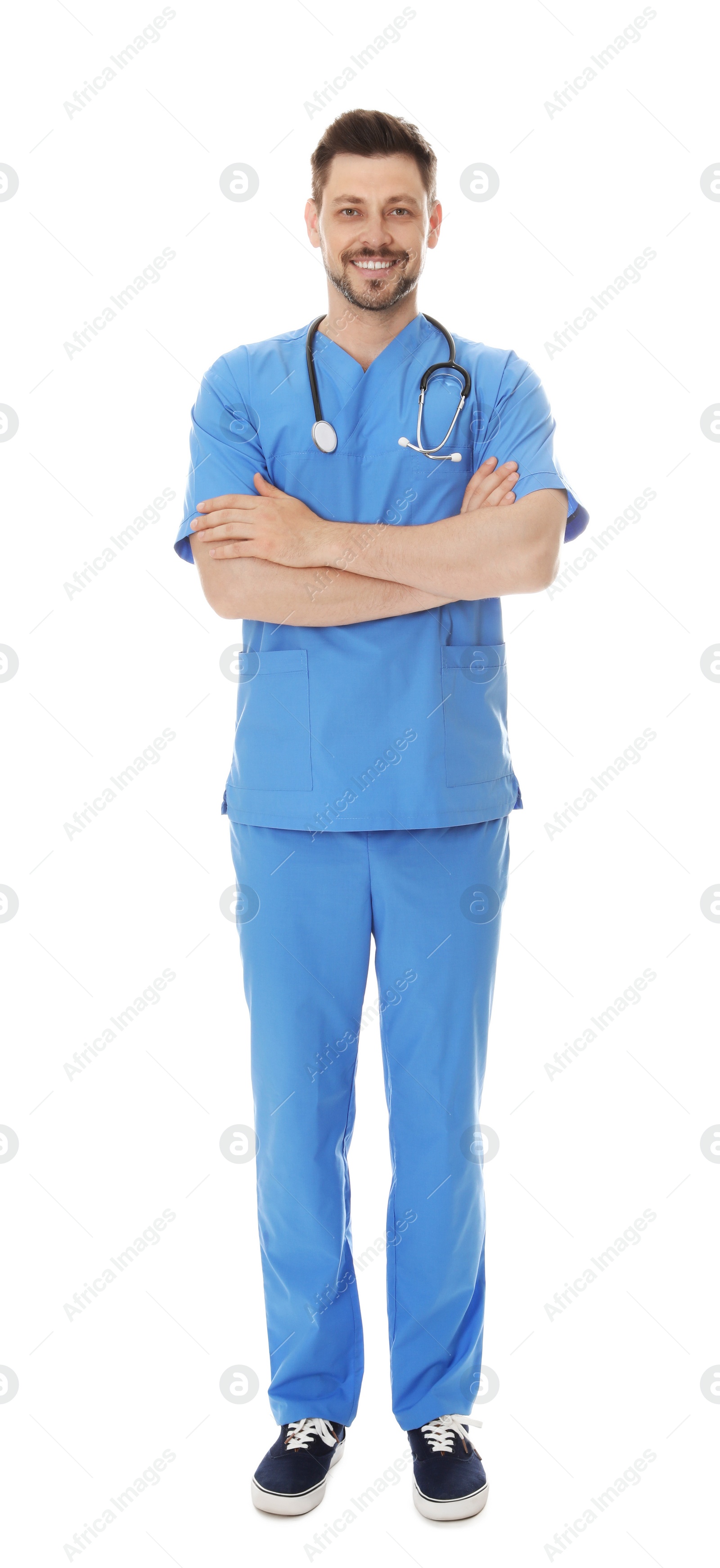 Photo of Full length portrait of smiling male doctor in scrubs isolated on white. Medical staff