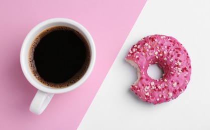 Photo of Tasty donut and cup of coffee on color background, flat lay