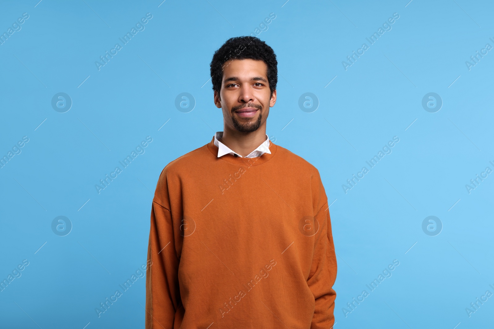 Photo of Portrait of handsome man on light blue background