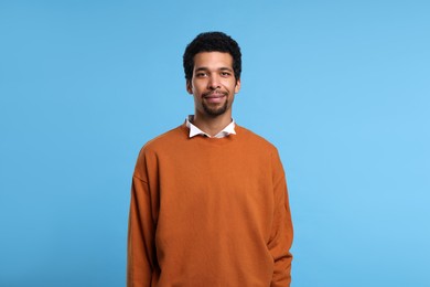 Portrait of handsome man on light blue background