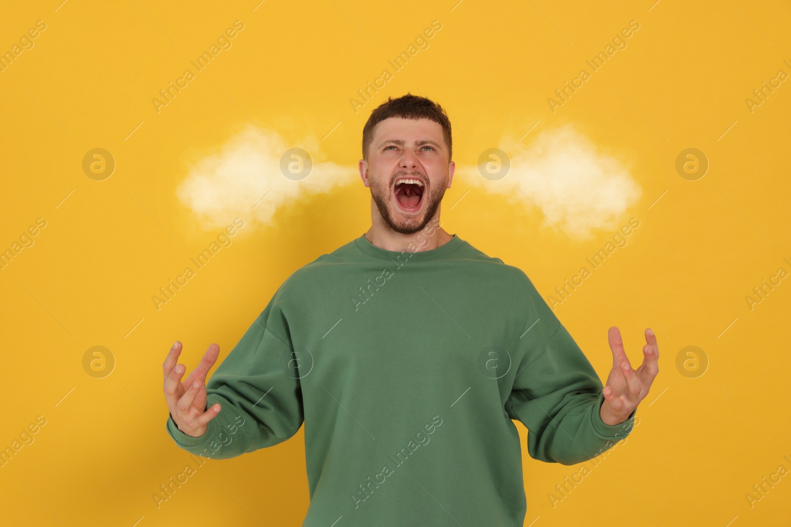 Image of Aggressive man with steam coming out of his ears on yellow background