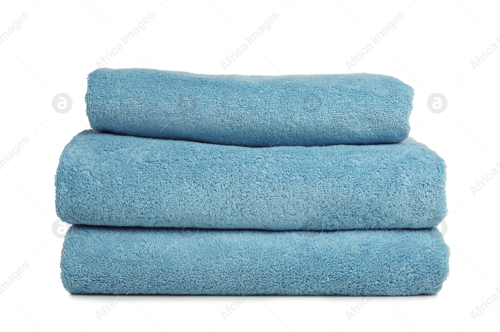 Photo of Folded soft terry towels on white background