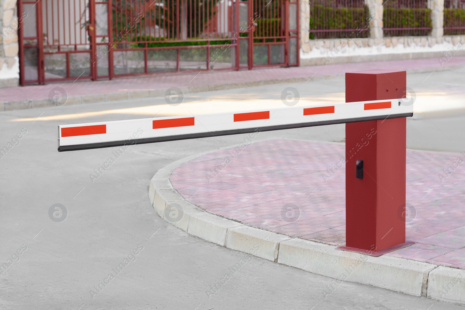 Photo of Closed boom barrier near road on autumn day outdoors