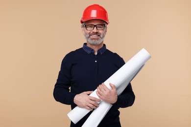 Architect in hard hat holding drafts on beige background