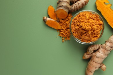 Photo of Aromatic turmeric powder and raw roots on green background, flat lay. Space for text