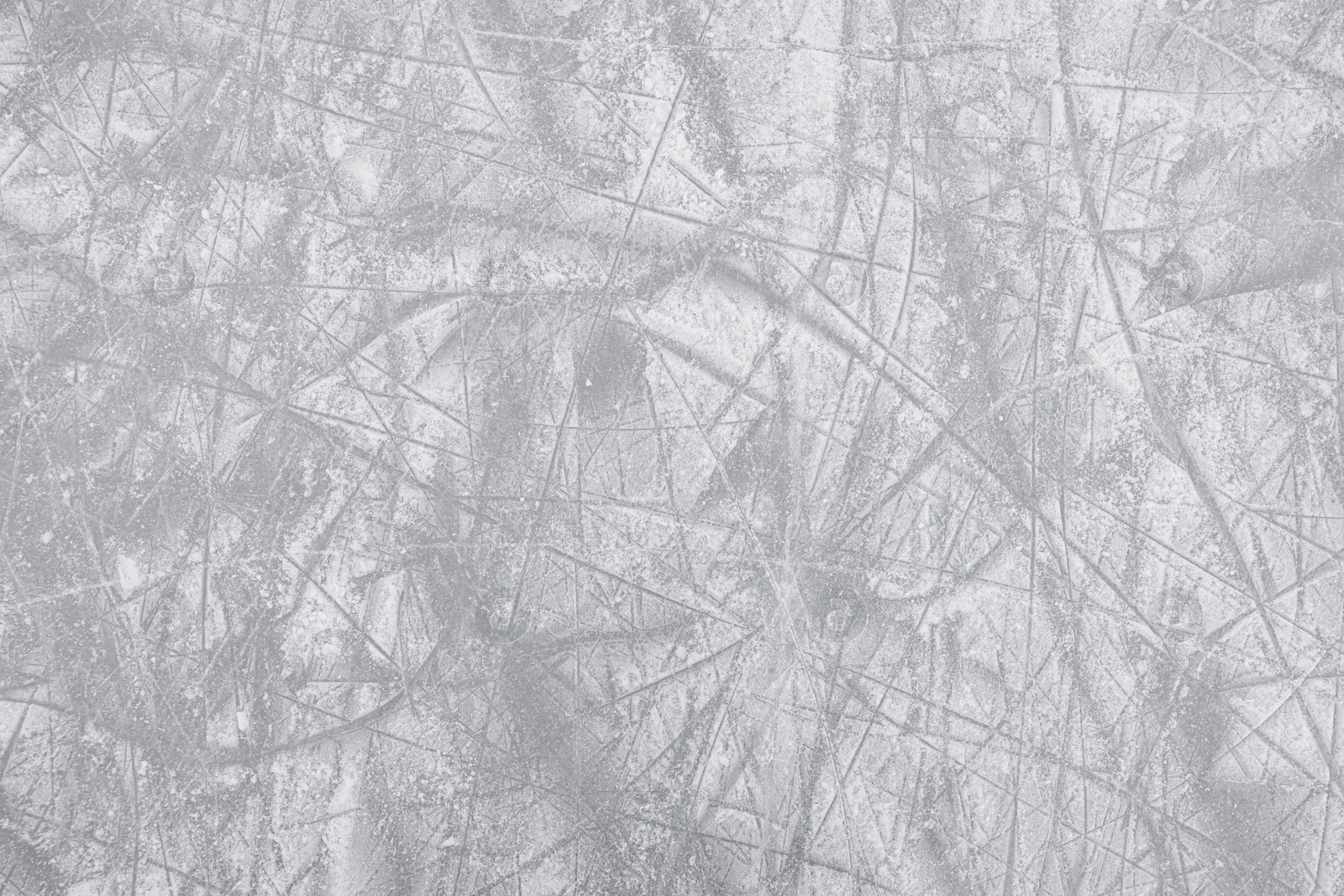 Photo of Frozen ice skating surface as background, top view. Winter season