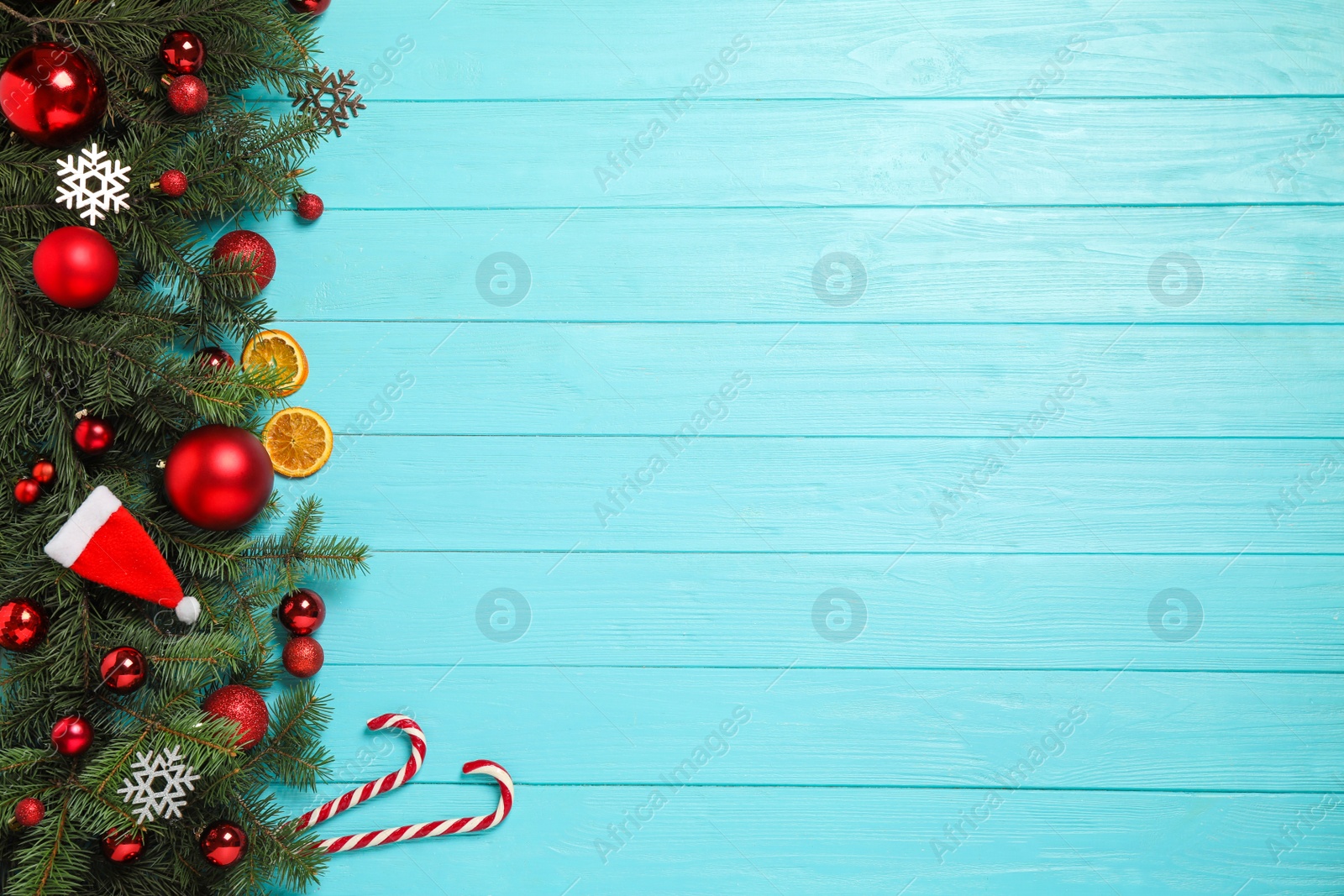 Photo of Fir branches with Christmas decoration on light blue wooden background, flat lay. Space for text