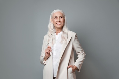 Photo of Portrait of beautiful mature woman on grey background