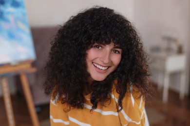 Photo of Portrait of happy young woman in stylish sweater indoors