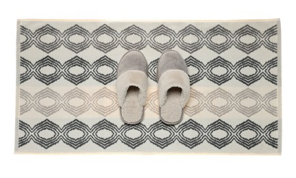 Soft bath mat and slippers isolated on white, top view