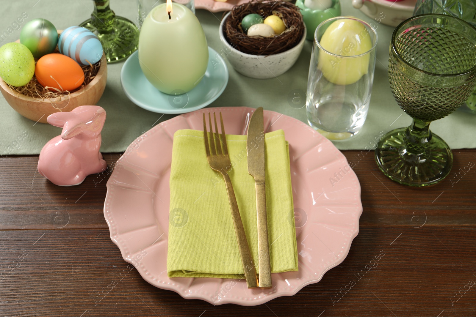 Photo of Easter celebration. Festive table setting with painted eggs.