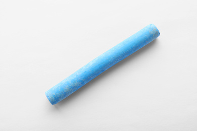 Photo of Piece of blue chalk isolated on white, top view