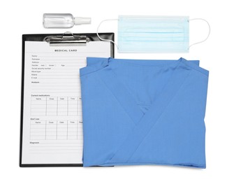 Photo of Medical uniform, face mask and clipboard on white background, top view