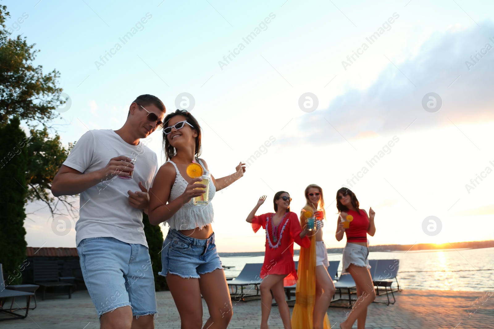 Photo of Group of happy people enjoying fun party outdoors