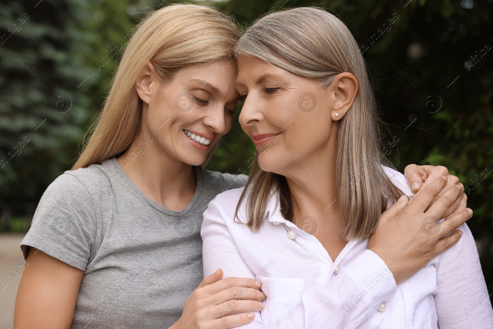 Photo of Happy mature mother and her daughter outdoors