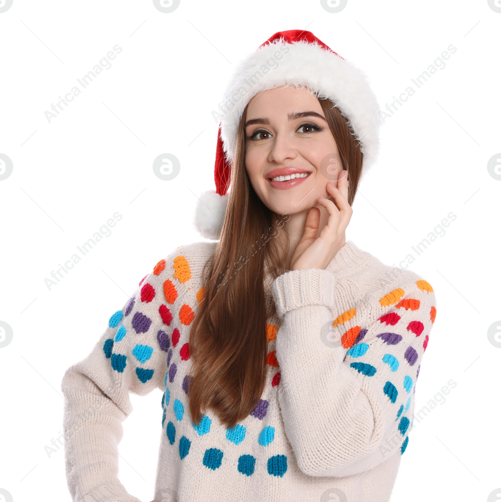 Photo of Happy young woman in sweater and Santa hat on white background. Christmas celebration