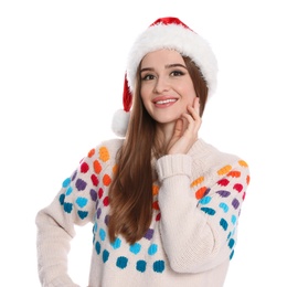 Happy young woman in sweater and Santa hat on white background. Christmas celebration