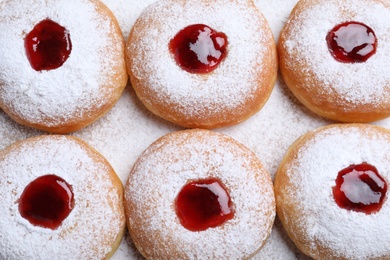 Photo of Hanukkah doughnuts with jelly and sugar powder, flat lay