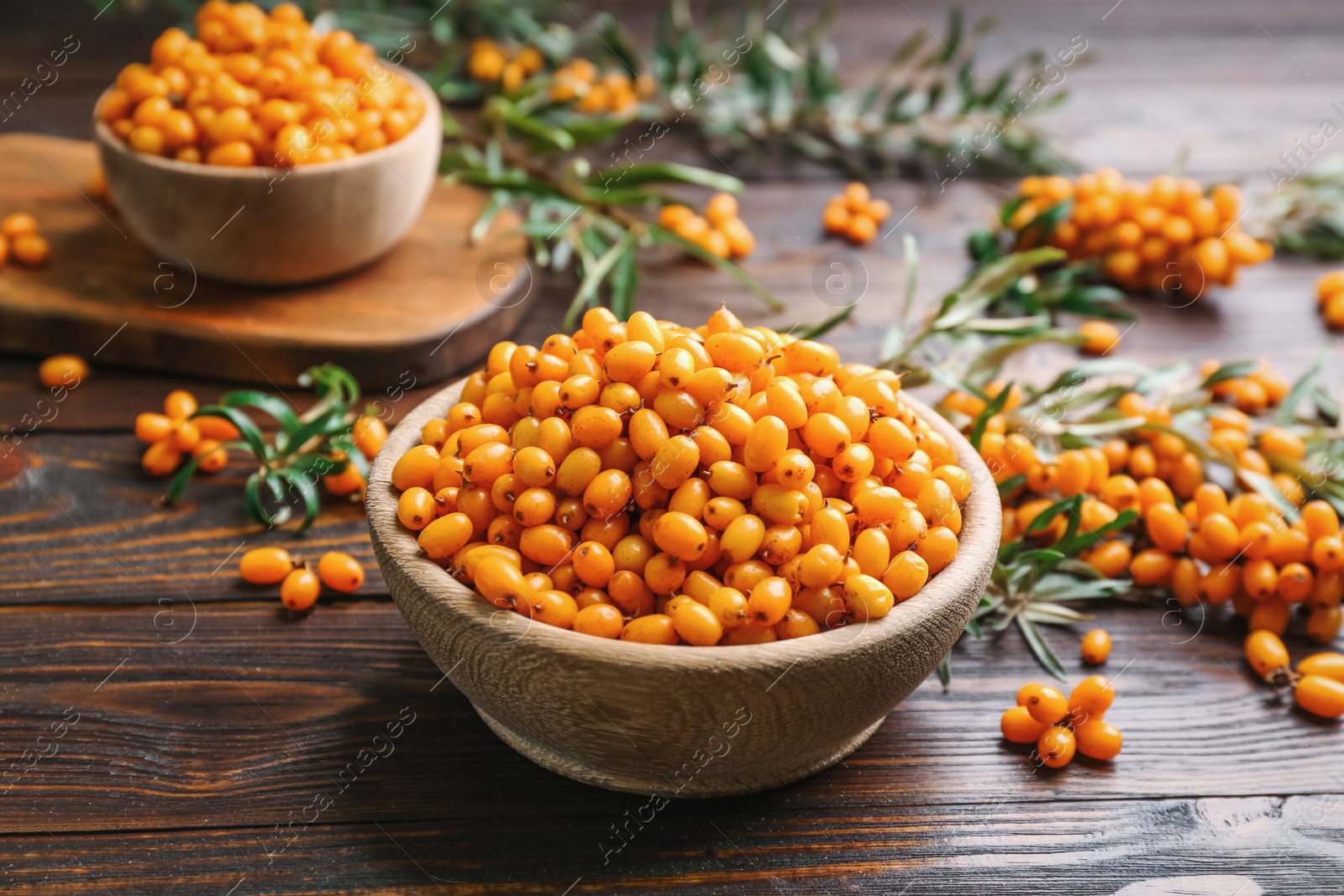 Photo of Fresh ripe sea buckthorn on wooden table