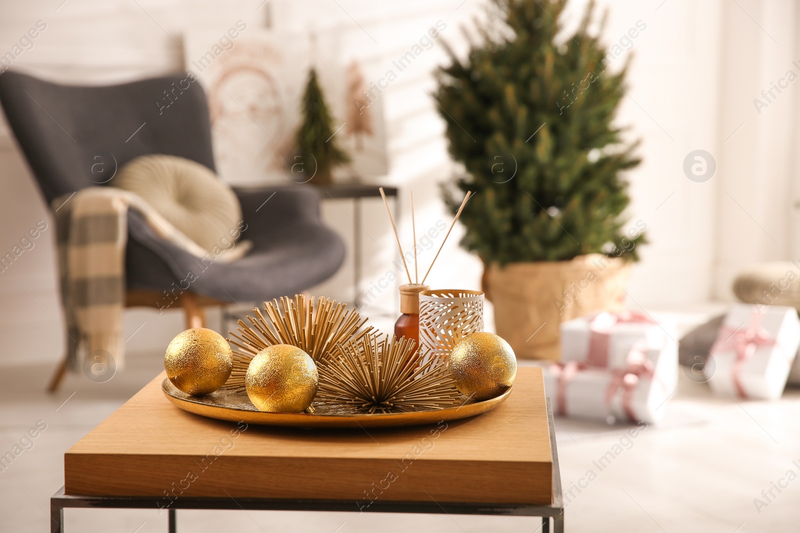 Photo of Elegant Christmas decor and reed diffuser on table indoors. Interior design