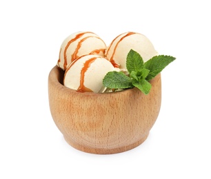Photo of Delicious ice cream with caramel sauce and mint in wooden bowl on white background