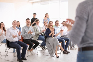 Photo of Young people having business training in office