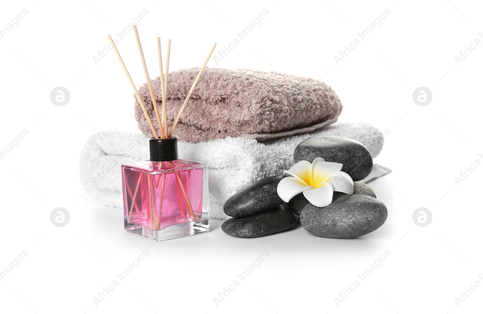 Photo of Beautiful composition with towels and spa stones on white background