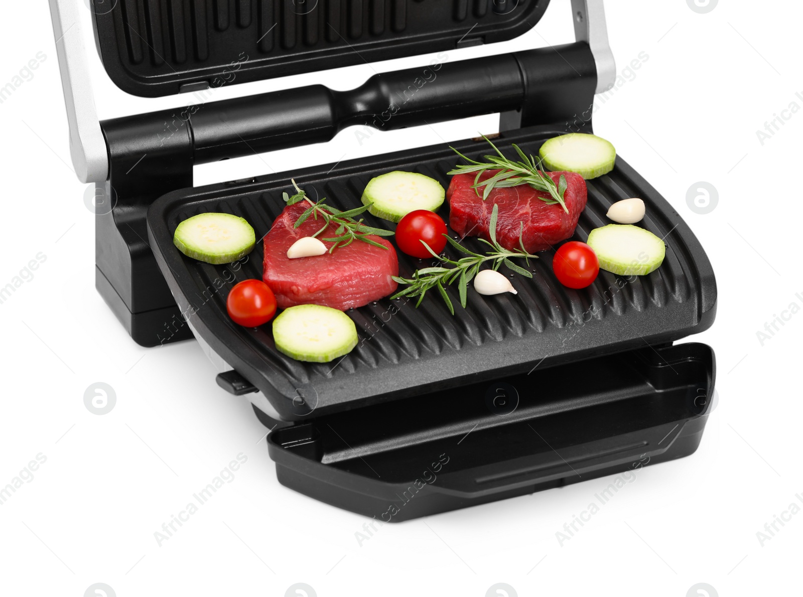 Photo of Electric grill with raw meat, rosemary and vegetables isolated on white