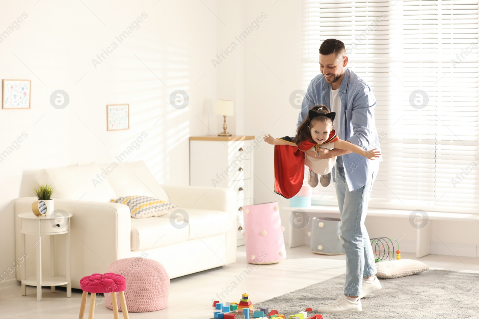 Photo of Father playing with his child at home