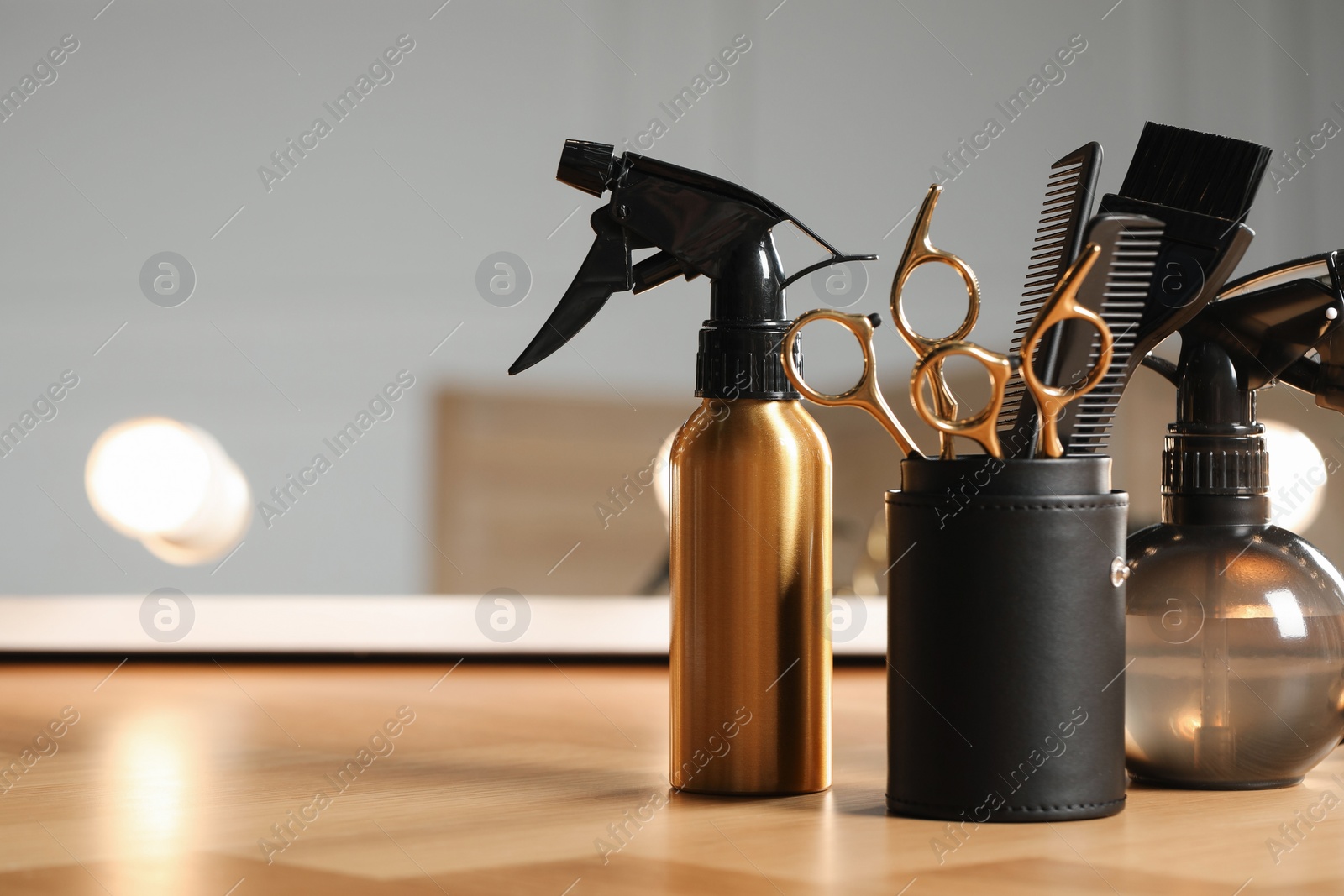 Photo of Set of hairdresser tools on table in salon, space for text