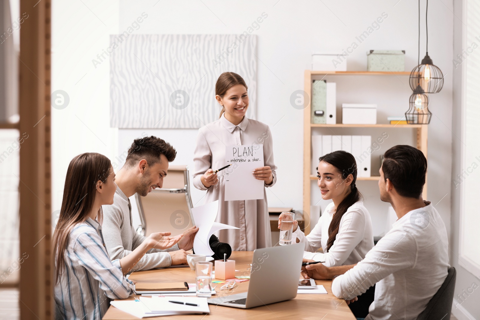 Photo of Team of professional journalists working in office