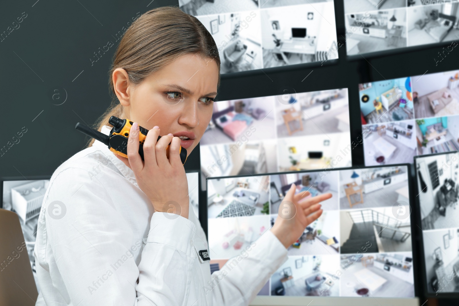 Photo of Emotional security guard using portable transmitter at workplace