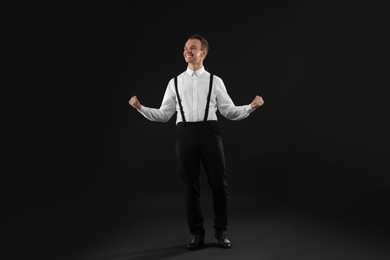 Photo of Cheerful man in white shirt on black background