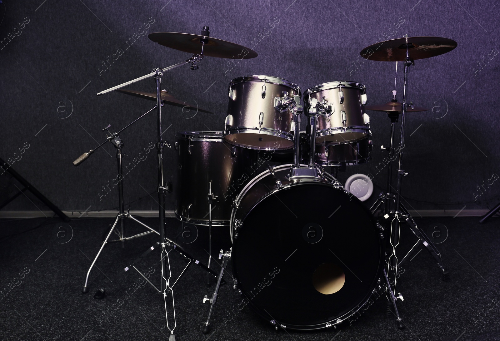 Photo of Modern drum set in recording studio. Music equipment