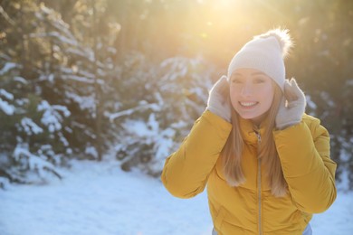 Woman enjoying winter day in forest, space for text
