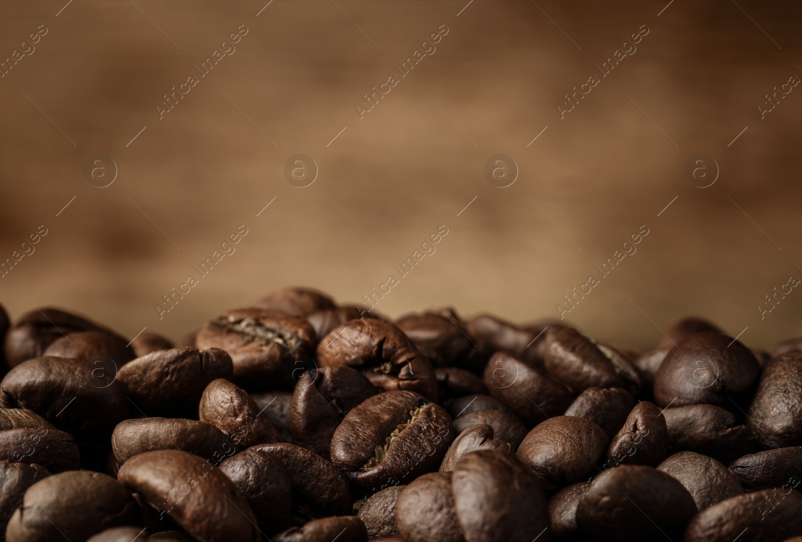 Photo of Heap of aromatic roasted coffee beans, closeup