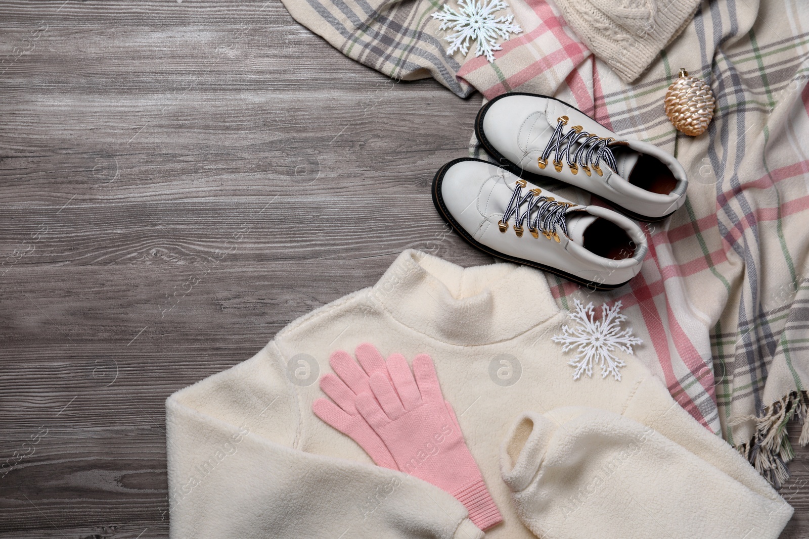 Photo of Winter fashion. Layout of women's outfit on wooden background, top view. Space for text