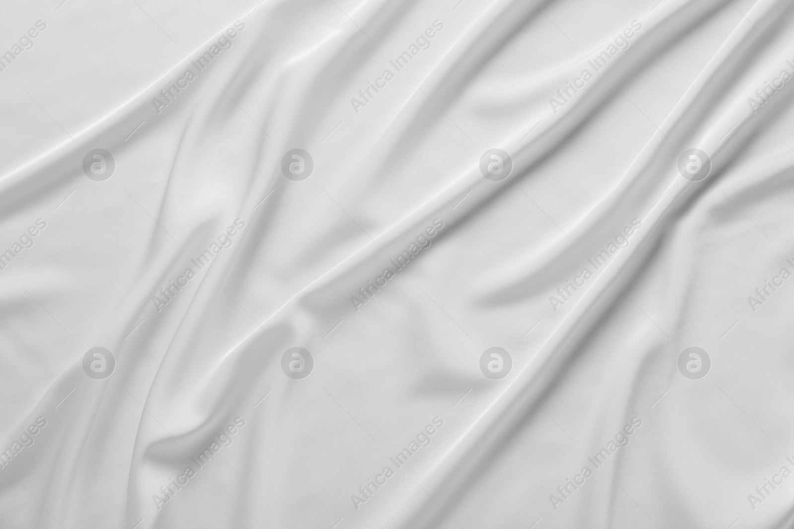 Photo of Texture of white silk ripple fabric as background, top view