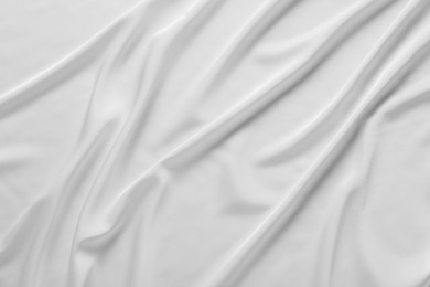 Photo of Texture of white silk ripple fabric as background, top view