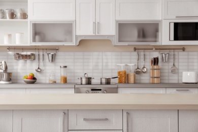 Photo of Countertop and blurred view of kitchen interior on background