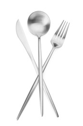 Photo of Shiny silver fork, spoon and knife isolated on white. Luxury cutlery set